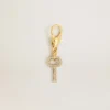 Ciondolo a forma di chiave in ottone color oro con cristalli