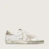 Super-Star da donna con bordo dorato scintillante e scritte con borchie metalliche