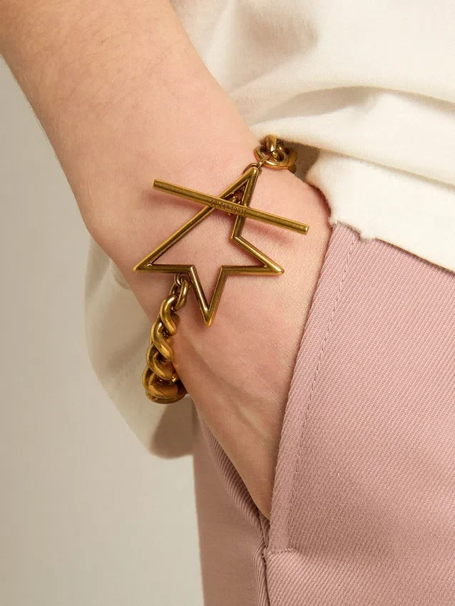 Bracciale con catena a maglie decrescenti color oro antico e chiusura a forma di stella