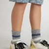 Calzini grigi da bambino con dettagli consumati e strisce bianche e blu dall’effetto consumato