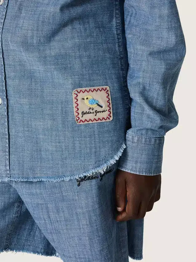 Camicia unisex Journey in chambray di cotone azzurro con orlo sfrangiato e toppa ricamata