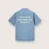 Camicie unisex in denim azzurro con ricamo sul retro