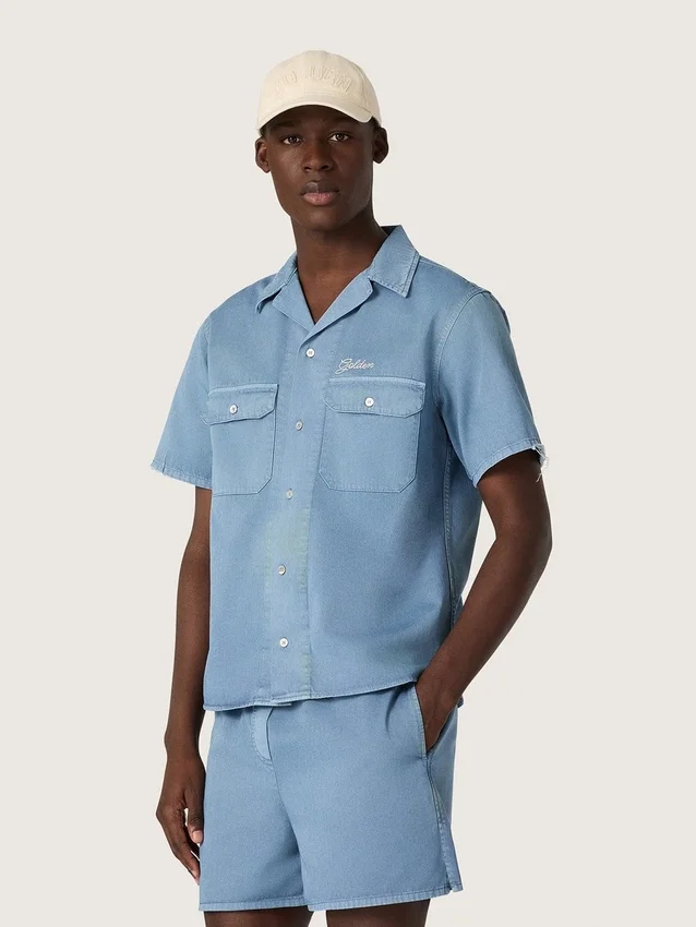 Camicie unisex in denim azzurro con ricamo sul retro