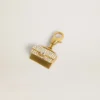 Ciondolo a forma di borsetta in ottone color oro con cristalli