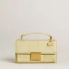 Ciondolo a forma di borsetta in ottone color oro con cristalli
