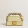 Ciondolo a forma di borsetta in ottone color oro con cristalli