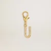 Ciondolo a forma di lettera U in ottone color oro con cristalli