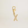 Ciondolo a forma di lettera X in ottone dorato con cristalli