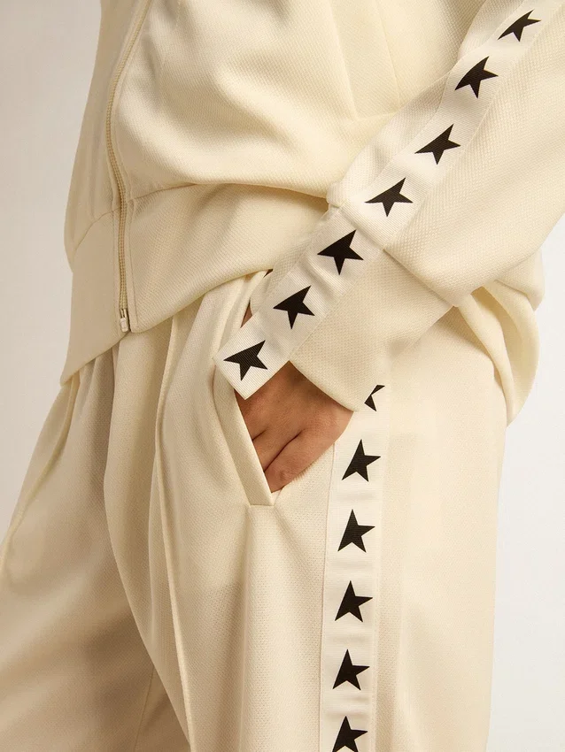 Felpa da donna bianca con zip, striscia bianca e stelle nere