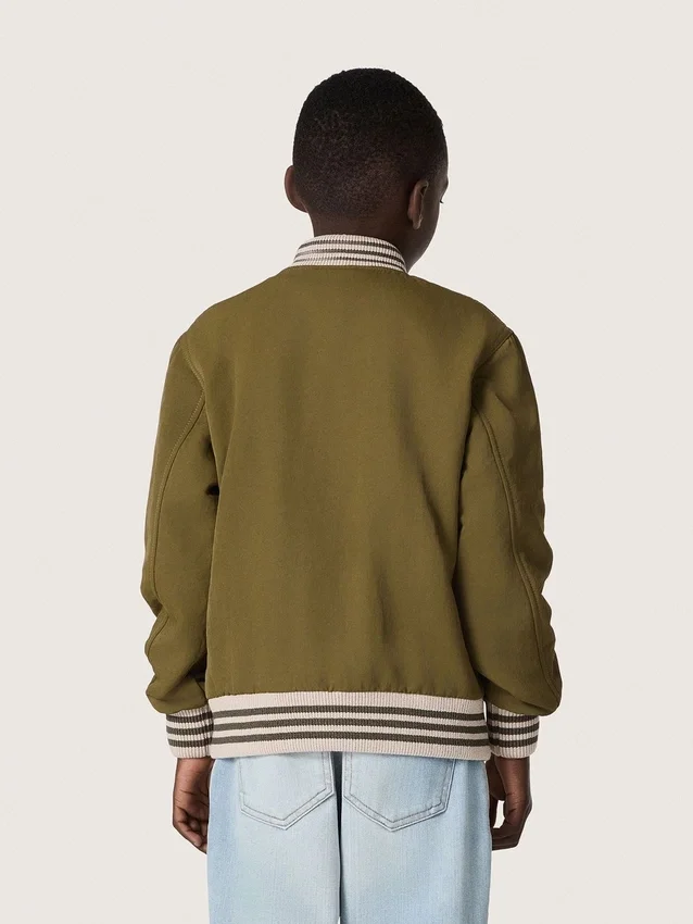 Giacca bomber unisex Journey in twill di nylon verde militare con toppa ricamata