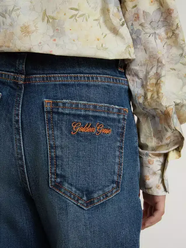Jeans bootcut da bambina con lavaggio medio e ricami