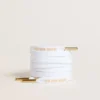 Lacci in cotone bianco con logo dorato a contrasto