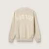 Maglione unisex a girocollo in cotone beige con toppa sul davanti e logo sul retro