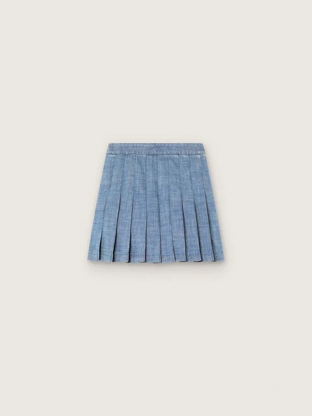 Minigonna a pieghe da bambina “Journey” in chambray di cotone azzurro con logo ricamato