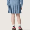 Minigonna a pieghe da bambina “Journey” in chambray di cotone azzurro con logo ricamato