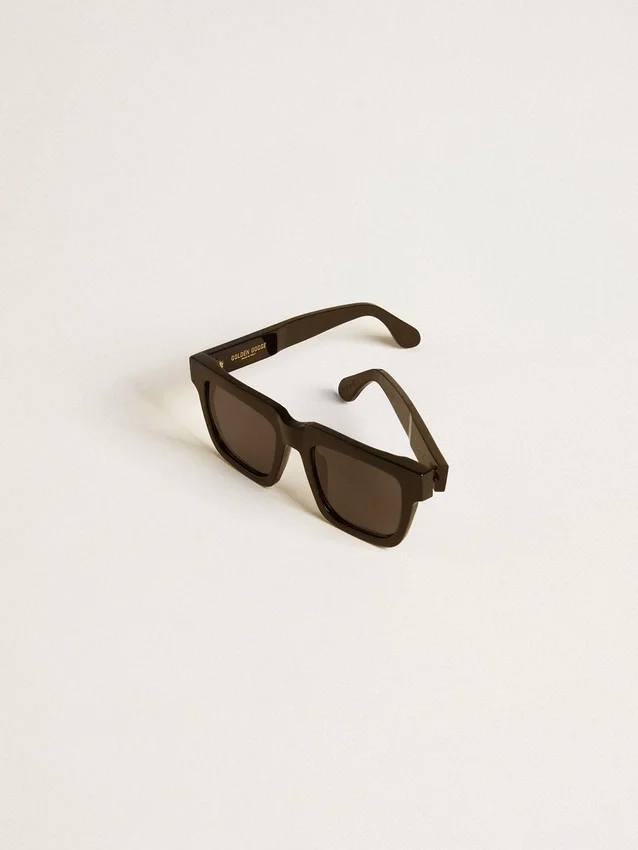 Occhiali da sole Jamie dal design squadrato con montatura nera e logo dorato