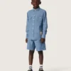 Camicia unisex Journey in chambray di cotone azzurro con orlo sfrangiato e toppa ricamata