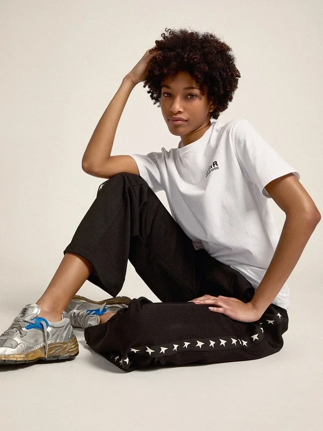 Pantaloni da jogging da donna neri con stelle bianche sui lati