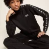 Pantaloni da jogging da donna neri con stelle bianche sui lati