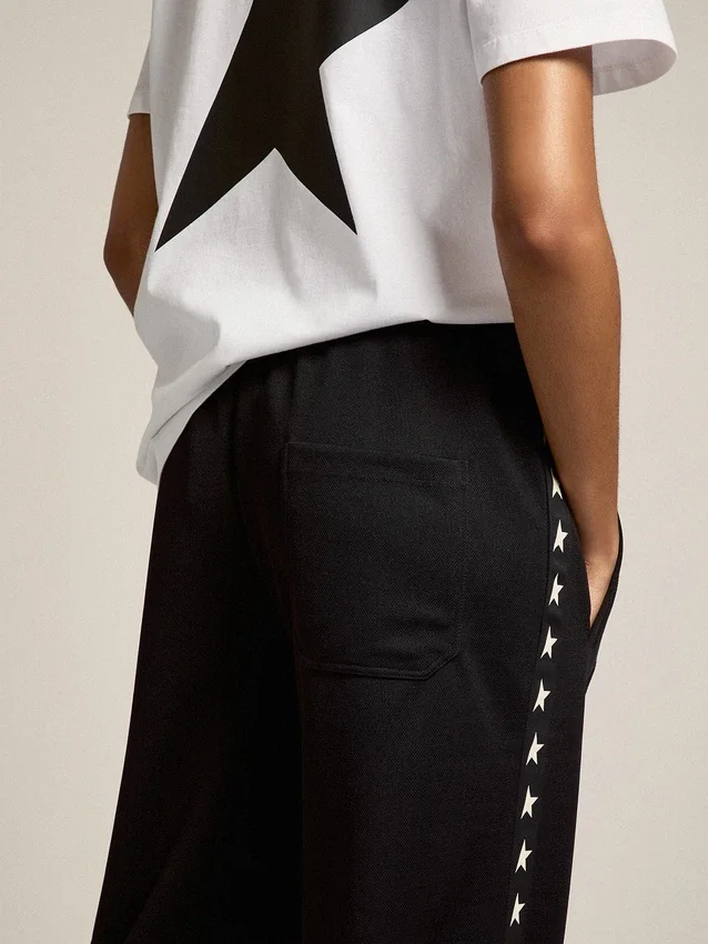 Pantaloni da jogging da donna neri con stelle bianche sui lati