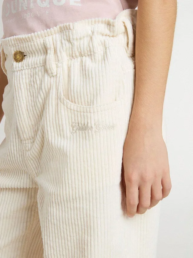 Pantaloni larghi a costine color crema per bambine con ricami