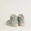 Slide da uomo in tela azzurra con inserto in pelle metallizzata argento