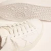 Sneakers Purestar da donna con linguetta sul tallone color oro