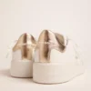 Sneakers Purestar da donna con linguetta sul tallone color oro