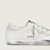 Super-Star da donna con bordo argentato scintillante e scritta con borchie metalliche