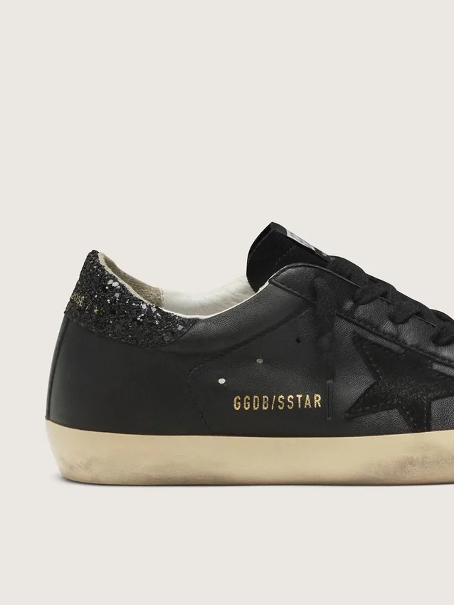 Super-Star da donna in nappa nera con stella nera e linguetta sul tallone glitterata