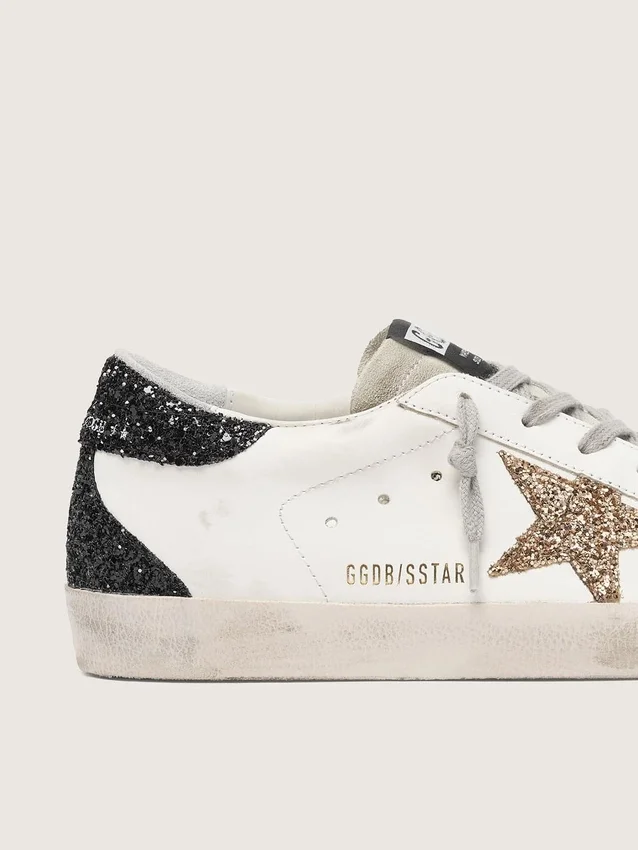 Super-Star da donna in pelle nappa con stella glitterata dorata e linguetta sul tallone nera glitterata
