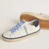 Super-Star Junior in pelle bianca con linguetta sul tallone in pelle scamosciata blu