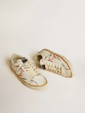Super-Star LTD da uomo con stella traforata e linguetta sul tallone in pelle metallizzata
