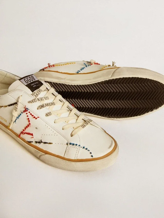 Super-Star LTD da uomo con stella traforata e linguetta sul tallone in pelle metallizzata