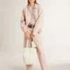Top in maglia a rete con paillettes e dettagli a contrasto