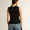Top in maglia a rete nera con paillettes e dettagli a contrasto